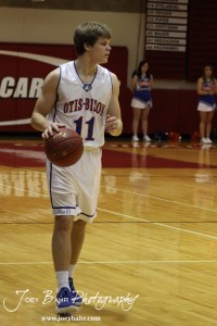Otis-Bison Cougar Dylan Wissman (#11) dribbles the ball down the court against the Ellsworth Bearcats at the 2012 Hoisington Winter Jam Basketball Tournament.