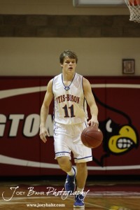 Otis-Bison Cougar Dylan Wissman (#11) dribbles the ball down the court against the Ellsworth Bearcats at the 2012 Hoisington Winter Jam Basketball Tournament.