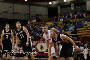 Ellsworth Bearcat Josh Bahr (#4) boxes out Otis-Bison Cougar Zachary Stejskal (#14) during a free throw at the 2012 Hoisington Winter Jam Basketball Tournament.