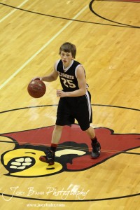 Ellsworth Bearcat Grant Glaser (#25) crosses the half court line against the Otis-Bison Cougars at the 2012 Hoisington Winter Jam Basketball Tournament.