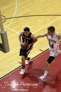 Ellsworth Bearcat Mark Cunningham (#11) goes up for a layup while Otis-Bison Cougar ob14 tries to catch up at the 2012 Hoisington Winter Jam Basketball Tournament.
