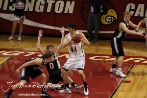 Ellsworth Bearcats Matthew Keener (#0) falls to the floor while Otis-Bison Cougar Brandon Pechanec (#44) moves towards the basket at the 2012 Hoisington Winter Jam Basketball Tournament.