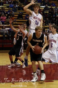 Otis-Bison Cougar Dylan Wissman (#11) elevates to block off the basket from Ellsworth Bearcat Josh Bahr (#4) during the 2012 Hoisington Winter Jam Basketball Tournament.