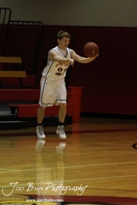 Otis-Bison Cougar Patrick Piper (#22) passes the ball against the Ellsworth Bearcats at the 2012 Hoisington Winter Jam Basketball Tournament.