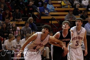 Otis-Bison Cougars Brandon Pechanec (#44) and Trevor Keller (#3) and Ellsworth Bearcat Shane Wilson (#3) watch the ball during a free throw attempt at the 2012 Hoisington Winter Jam Basketball Tournament.