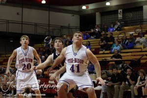 Otis-Bison Cougars Colin Regan (#20) and Sam Higgason (#41) seal off Ellsworth Bearcat McGregor Jones (#13) from a rebound after a missed free-throw at the 2012 Hoisington Winter Jam Basketball Tournament.