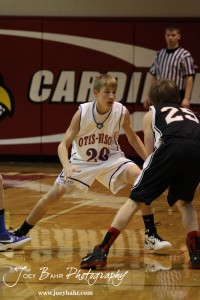 Otis-Bison Cougar Colin Regan (#20) tries to defend Ellsworth Bearcat Grant Glaser (#25) at the 2012 Hoisington Winter Jam Basketball Tournament.