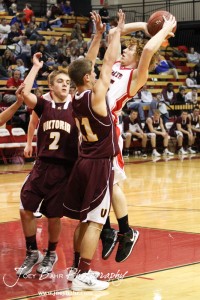 Clint Glaser (#15) of the Ellsworth Bearcats takes a shot against Victoria Knight Bryan Dome (#21) at the 2012 Hoisington Winter Jam Basketball Tournament.