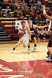 Ellsworth Bearcat Shane Wilson (#3) drives past Victoria Knight Bryan Dome (#21) at the 2012 Hoisington Winter Jam Basketball Tournament.