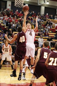 Josh Bahr (#4) of the Ellsworth Bearcats goes up for a shot against the defense of Victoria Knight Phillip Nowak (#40) at the 2012 Hoisington Winter Jam Basketball Tournament.