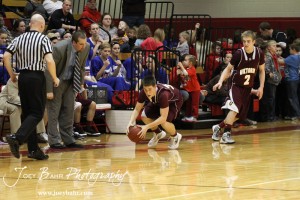 Tanner Hobbs (#33) of the Victoria Knights scoops up the ball against the Ellsworth Bearcats at the 2012 Hoisington Winter Jam Basketball Tournament.