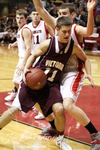 Sam Ottley (#11) of the Victoria Knights drives into the Ellsworth Bearcats defense at the 2012 Hoisington Winter Jam Basketball Tournament.