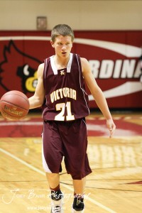 Bryan Dome (#21) of the Victoria Knights looks for someone to pass the basketball to against the Ellsworth Bearcats at the 2012 Hoisington Winter Jam Basketball Tournament.