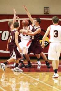Victoria Knights defenders collapse around Ben Murrell (#23) of the Ellsworth Bearcats at the 2012 Hoisington Winter Jam Basketball Tournament.