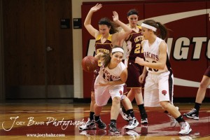 Ellsworth Lady Bearcat Maycee Jones (#13) dribbles around a Victoria Lady Knights defender at the 2012 Hoisington Winter Jam Basketball Tournament.
