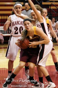 Victoria Lady Knights Kaley Goetz (#22) attempts to go up with a shot against Ellsworth Lady Bearcat Rachel Herzog (#5) during the 2012 Hoisington Winter Jam Basketball Tournament.