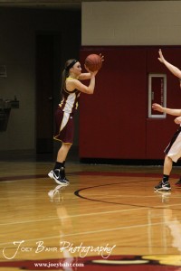 Victoria Lady Knights Rylee Broyles (#20) takes a shot behind the three point line against the Ellsworth Lady Bearcats during the 2012 Hoisington Winter Jam Basketball Tournament.