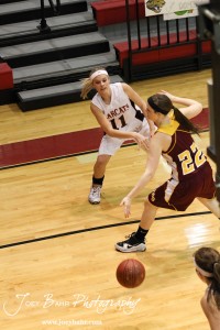 Ellsworth Lady Bearcat Brenn Cravens (#11) throws a pass around Victoria Lady Knights' Kaley Goetz (#22) at the 2012 Hoisington Winter Jam Basketball Tournament.