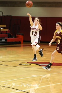 Ellsworth Lady Bearcats' Brenn Cravens (#11) throws a pass down the court to a teammate against the Victoria Lady Knights at the 2012 Hoisington Winter Jam Basketball Tournament.