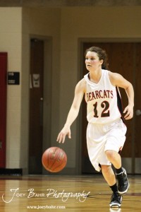 Kailee Landon (#12) of the Ellsworth Lady Bearcats drives down the court with the basketball against the Victoria Lady Knights at the 2012 Hoisington Winter Jam Basketball Tournament.