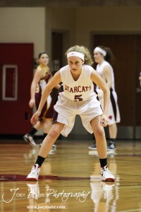 Rachel Herzog (#5) of the Ellsworth Lady Bearcats waits to pick up the Victoria Lady Knights point guard at the 2012 Hoisington Winter Jam Basketball Tournament.