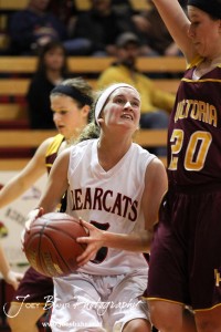 Rachel Herzog (#5) of the Ellsworth Lady Bearcats prepares to go up for a shot while being defended by Rylee Broyles (#20) of the Victoria Lady Knights at the 2012 Hoisington Winter Jam Basketball Tournament.