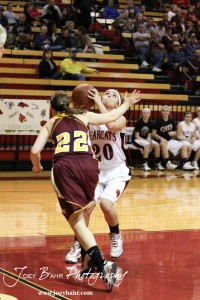 Connor Davis (#20) of the Ellsworth Lady Bearcats looks to take a shot while being defended by Kaley Goetz (#22) of the Victoria Lady Knights at the 2012 Hoisington Winter Jam Basketball Tournament.