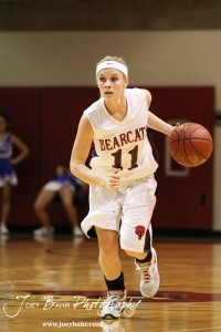 Brenn Cravens (#11) of the Ellsworth Lady Bearcats drives the ball down the court against the Victoria Lady Knights at the 2012 Hoisington Winter Jam Basketball Tournament.