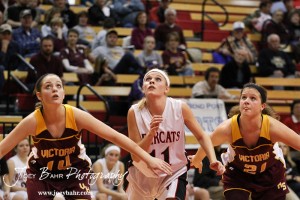 Victoria Lady Knights Brooke Pfanenstiel (#14) and Ashley Dome (#21) watch along with Ellsworth Lady Bearcat Brenn Cravens (#11) as the basketball flies towards the rim at the 2012 Hoisington Winter Jam Basketball Tournament.