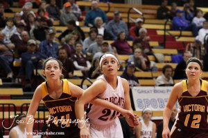Victoria Lady Knight Brooke Pfanenstiel (#14) blocks out Connor Davis (#20) of the Ellsworth Lady Bearcats at the 2012 Hoisington Winter Jam Basketball Tournament.