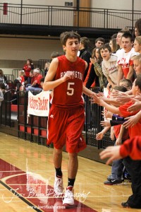 Ryan Becker (#5) of the Hoisington Cardinals greets fans before taking on the Minneapolis Lions at the 2012 Hoisington Winter Jam Basketball Tournament.