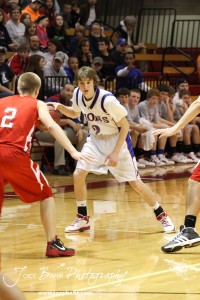 Josh Macy (#2) of the Minneapolis Lions looks over the Hoisington Cardinal defense at the 2012 Hoisington Winter Jam Basketball Tournament.