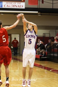 Minneapolis Lion John Darrow (#5) takes a shot against the Hoisington Cardinals at the 2012 Hoisington Winter Jam Basketball Tournament.