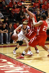 Andrew Yoxall (#3) of the Minneapolis Lions tries to drive along the baseline against the Hoisington Cardinal defense at the 2012 Hoisington Winter Jam Basketball Tournament.