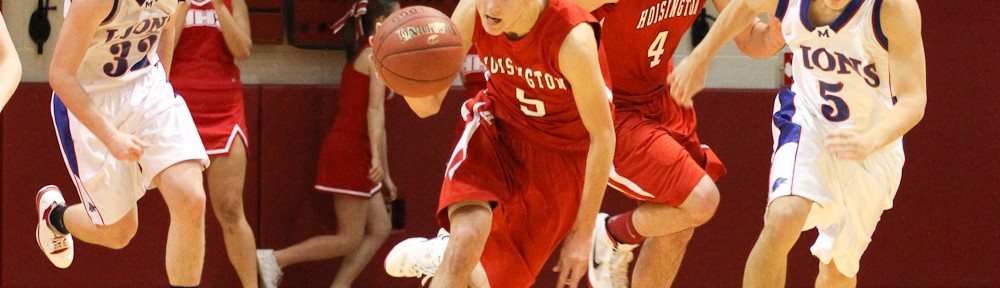 Ryan Becker (#5) of the Hoisington Cardinals drives down the court with the basketball against the Minneapolis Lions at the 2012 Hoisington Winter Jam Basketball Tournament.