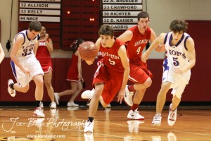 Ryan Becker (#5) of the Hoisington Cardinals drives down the court with the basketball against the Minneapolis Lions at the 2012 Hoisington Winter Jam Basketball Tournament.