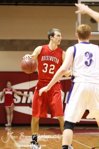 Hoisington Cardinal Derrick Kaiser (#32) looks for a teammate to pass the ball to against the Minneapolis Lions defense at the 2012 Hoisington Winter Jam Basketball Tournament.