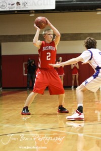 Hoisington Cardinal Trent Schremmer (#2) looks for a teammate to pass the ball to against the Minneapolis Lions at the 2012 Hoisington Winter Jam Basketball Tournament.