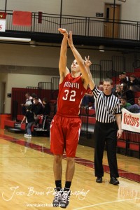 Hoisington Cardinal Derrick Kaiser (#32) shoots a three point shot against the Minneapolis Lions at the 2012 Hoisington Winter Jam Basketball Tournament.