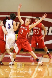 Hoisington Cardinal Jacob Durrett (#3) tries to stop John Darrow (#5) of the Minneapolis Lions at the 2012 Hoisington Winter Jam Basketball Tournament.