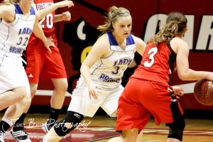 Tori Ptacek (#31) of the Russell Lady Broncos defends against Hoisington Lady Cardinal Mykela Riedl (#3) at the 2012 Hoisington Winter Jam Basketball Tournament.