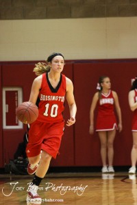 Jordin Greer (#10) of the Hoisington Lady Cardinals dribbles the ball down the court against the Russell Lady Broncos at the 2012 Hoisington Winter Jam Basketball Tournament.