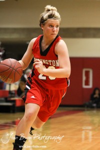 Blakelee Cooper (#23) of the Hoisington Lady Cardinals drives towards the Russell Lady Broncos defense at the 2012 Hoisington Winter Jam Basketball Tournament.