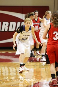 Madison Beagley (#12) of the Russell Lady Broncos prepares to defend Hoisington Lady Cardinal Mykela Riedl (#3) at the 2012 Hoisington Winter Jam Basketball Tournament.