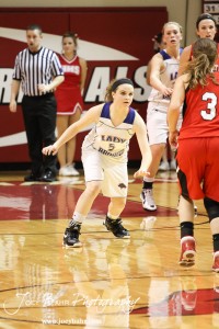 Russell Lady Bronco Alex Ptacek (#5) lines up to defend Mykela Riedl (#3) of the Hoisington Lady Cardinals at the 2012 Hoisington Winter Jam Basketball Tournament.