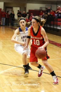 Hoisington Lady Cardinal Jordin Greer (#10) drives past Kaitlyn Walker (#24) of the Russell Lady Broncos at the 2012 Hoisington Winter Jam Basketball Tournament.