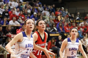 Russell Lady Broncos Kelli Rourke (#21) and Alex Ptacek (#5) watch a free throw attempt along with Savannah Rose (#15) of the Hoisington Lady Cardinal at the 2012 Hoisington Winter Jam Basketball Tournament.