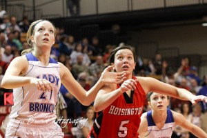 Russell Lady Bronco Kelli Rourke (#21) and Hoisington Lady Cardinal BreAnna Burns (#5) go for a rebound after a free throw attempt at the 2012 Hoisington Winter Jam Basketball Tournament.