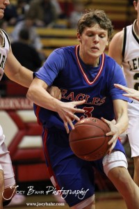Cody Isern (#23) of the Ellinwood Eagles drives into the defense of the LaCrosse Leopards at the 2012 Hoisington Winter Jam Basketball Tournament.