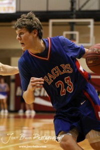 Ellinwood Eagle Cody Isern (#23) drives the ball against the LaCrosse Leopards at the 2012 Hoisington Winter Jam Basketball Tournament.